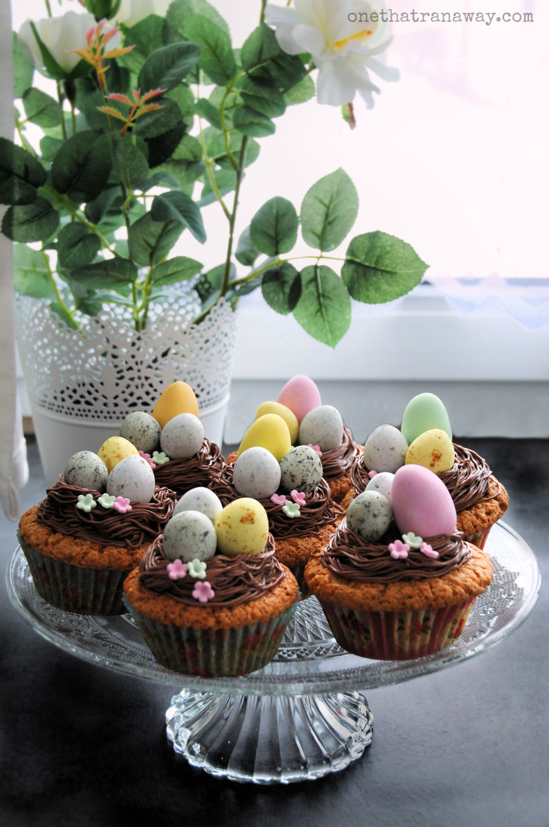 last minute easter nest cupcakes on a glass platter by the window