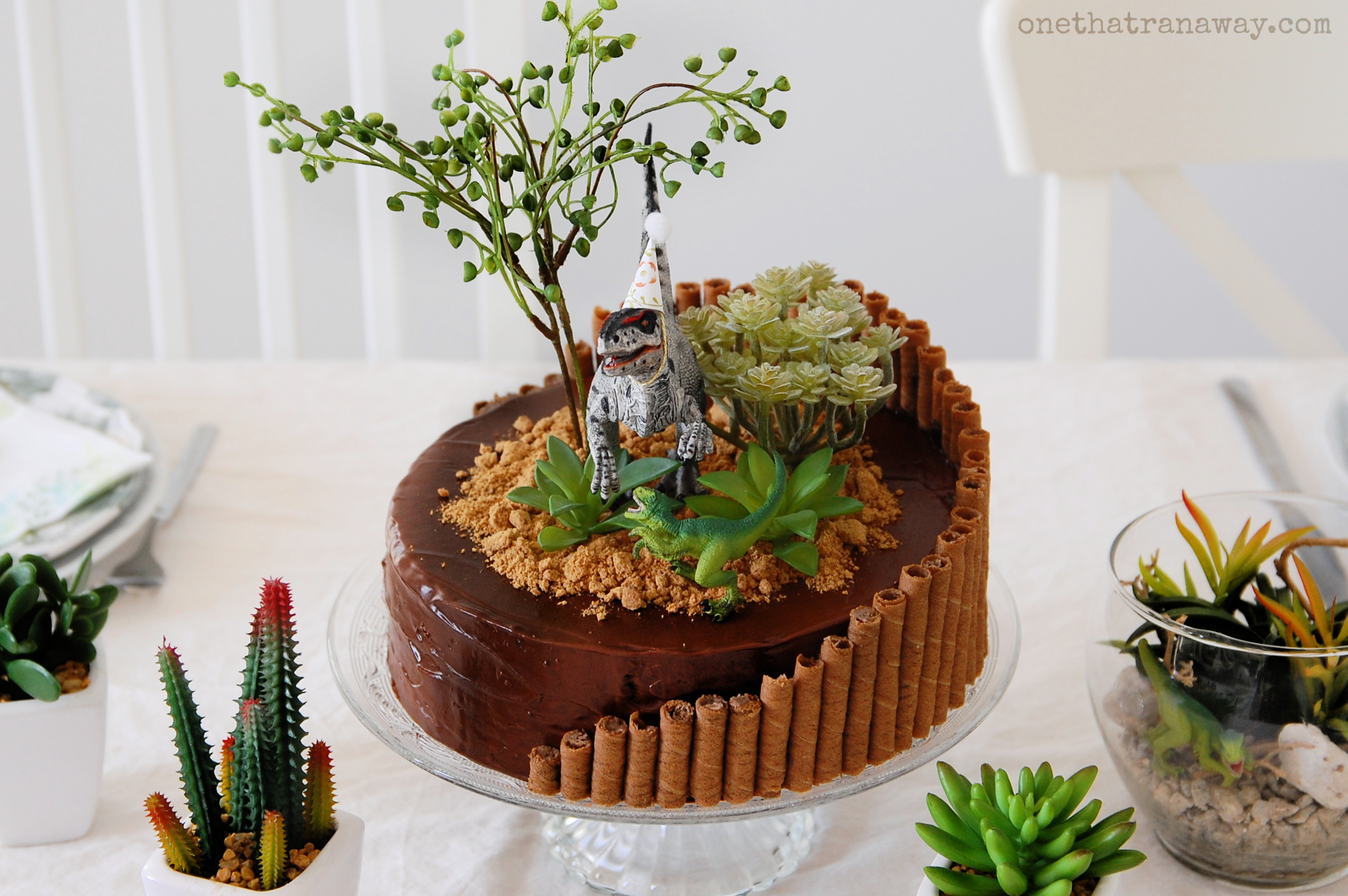 dinosaur birthday cake on a table