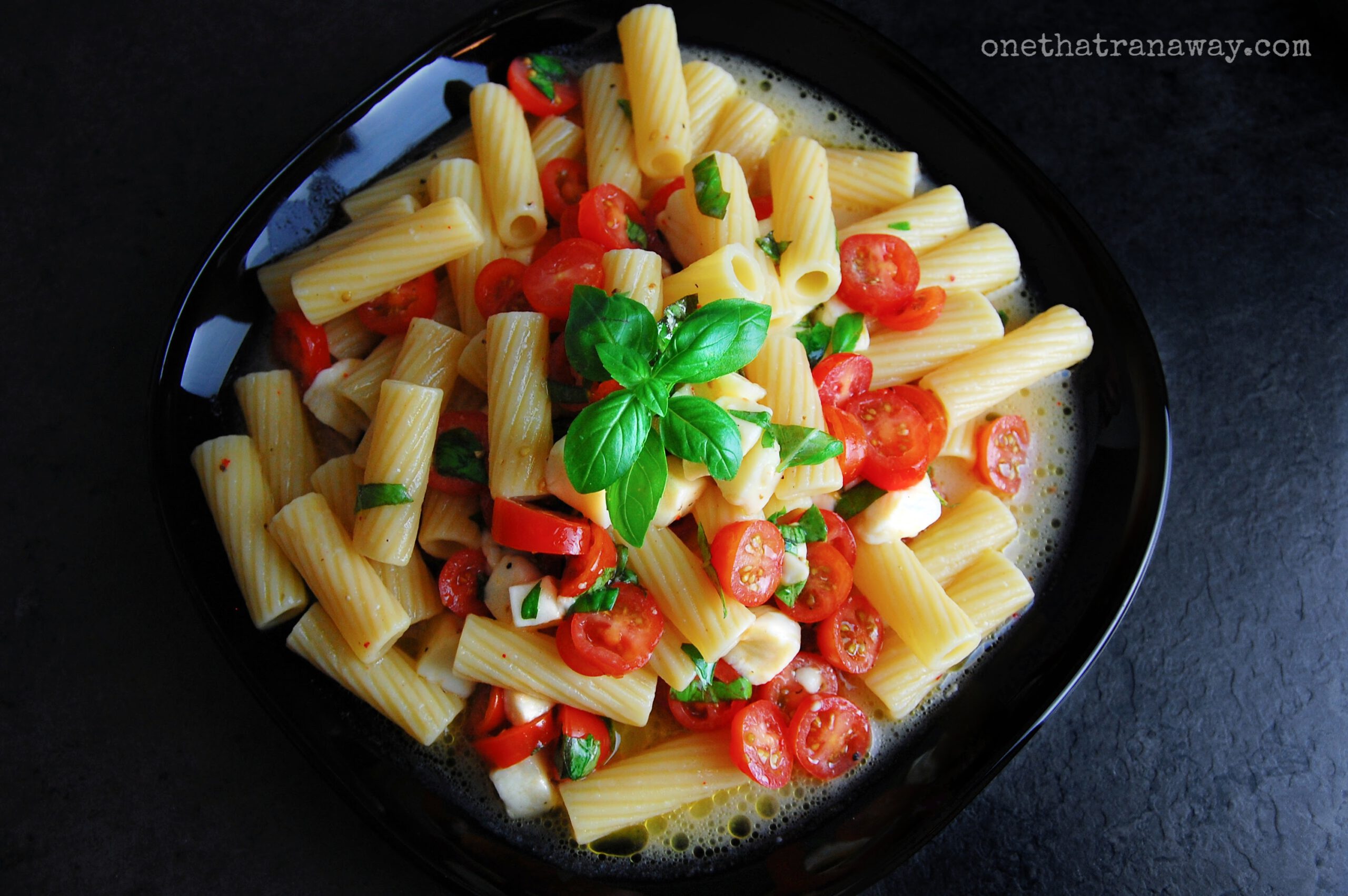 plate of pasta with cherry tomatoes and mozzarella