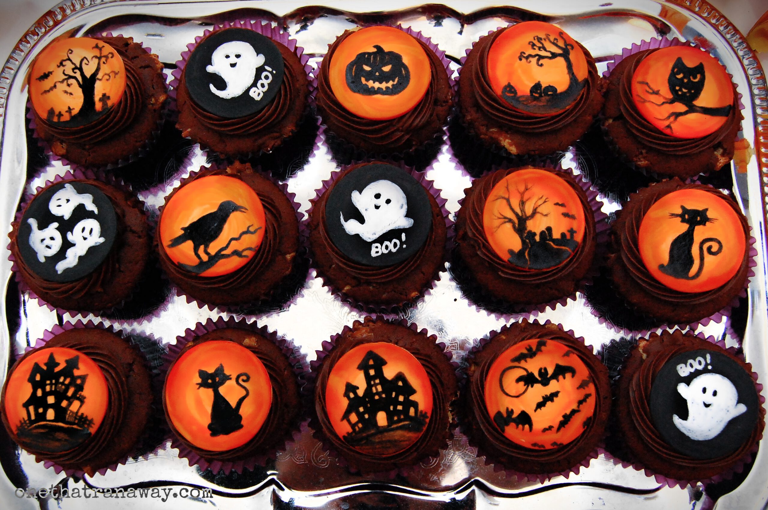 Halloween silhouette cupcake toppers on chocolate cupcakes on silver tray
